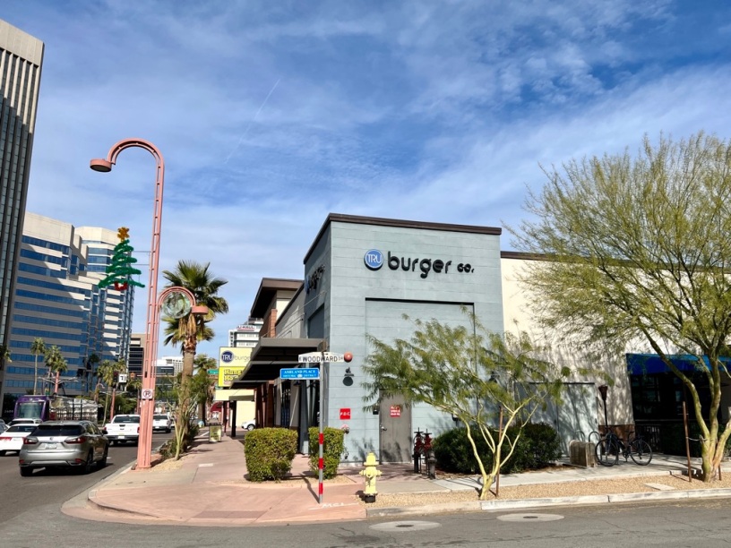 exterior of Tru Burger with trains and cars passing on Central Avenue